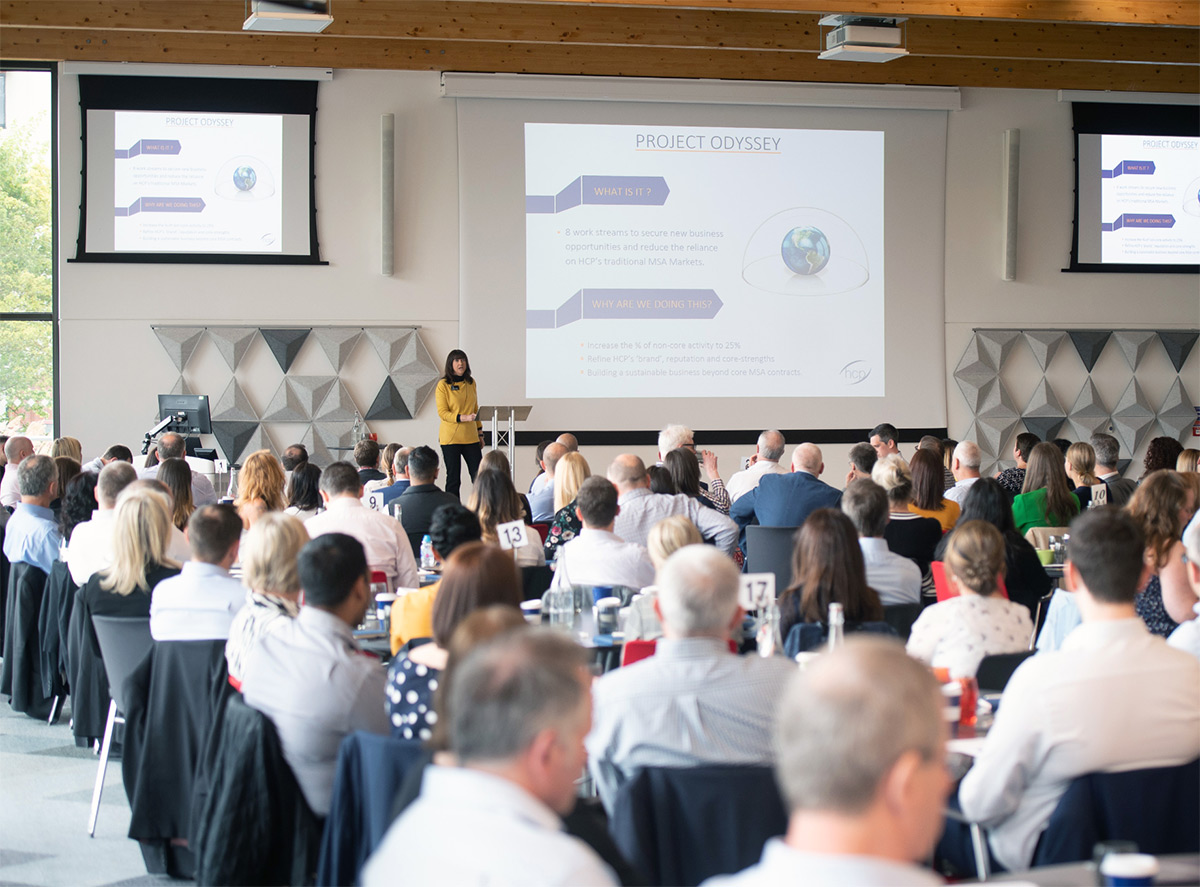 Career Growth A large group of people listening to a presentation