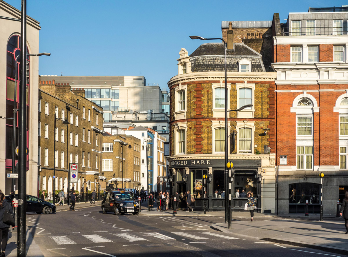 Image of pedestrian crossing on Beech Street towards Chiswell Street with The Jugged Hare pub / gastropub, in City of London, UK