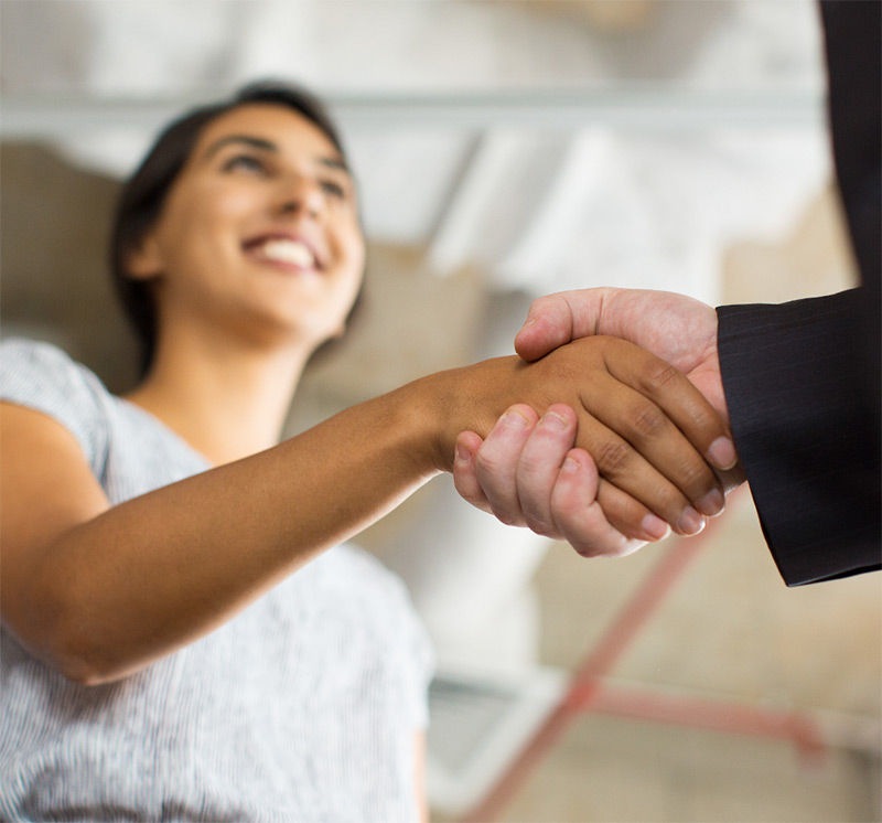 A man and a woman shaking hands to illustrate process