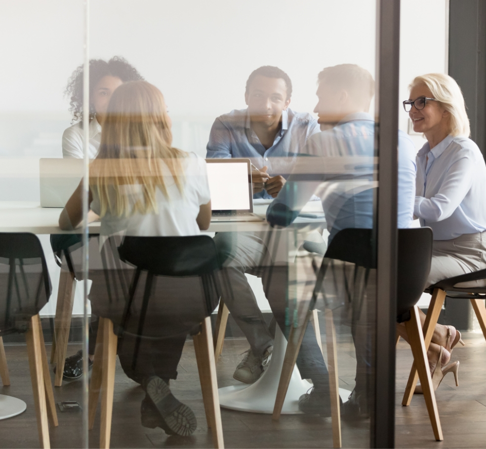 group of people sitting round an office desk